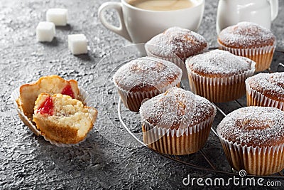 Coffee muffins on a wooden Board. Sweet muffins with berry filling on the table. Stock Photo