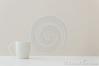 A coffee mug on table over light background. Stock Photo