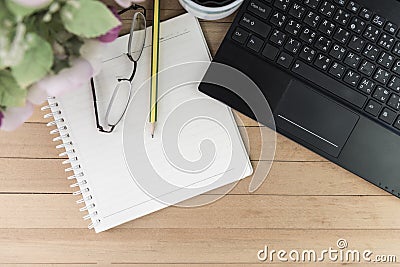 coffee with notebook,flower,pencil,eye glasses on wood background vintage style Stock Photo