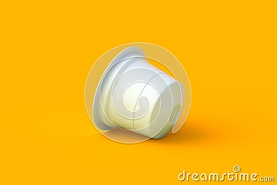 Coffee pod on orange background. Modern decaf capsule for machine. Stock Photo