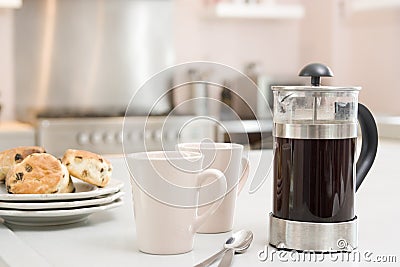 Coffee pot on kitchen counter with scones Stock Photo