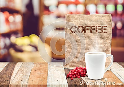 Coffee sack bag with coffee cup and smoke with blur cafe background,mock up for adding your text Stock Photo