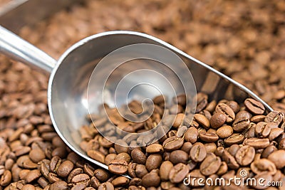 Alluminium coffee scoop with coffe beans Stock Photo