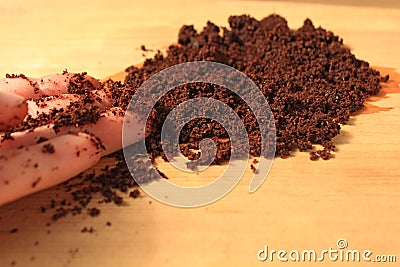 Coffee scrub for face and body, mask, cosmetics and care, wet ground coffee texture on wooden background Stock Photo