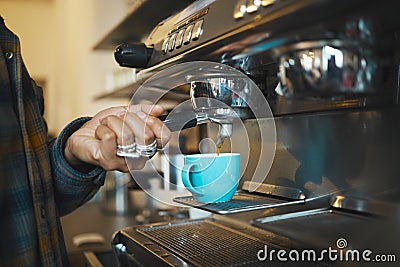 Coffee shop machine handle, hand of barista brewing espresso in restaurant and closeup of hot water beverage in cafe Stock Photo