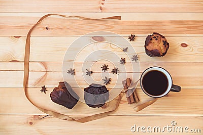 Coffee, spices and muffins on wooden background. Stock Photo
