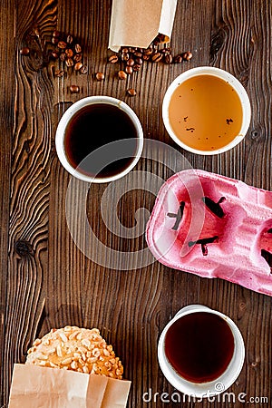 Coffee take out. Coffee cups with covers, coffee beans and cookies on wooden table backound top view copyspace Stock Photo