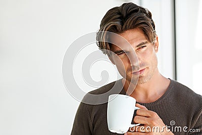 Coffee, thinking and handsome man at apartment with memory, vision or reflection face expression. Young, morning and Stock Photo