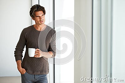 Coffee, thinking and young man at apartment with memory, vision or reflection face expression. Handsome, morning and Stock Photo