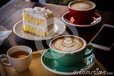 Coffee time in the wood table cafe , drink coffee and tasty cake Stock Photo