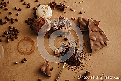 Coffee trace and roasted beans,ground coffee on spoon, macarons, chocolate, cinnamon on brown background. Coffee moody image Stock Photo
