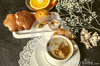 Coffee in white cup and saucer dishes with cakes and chocolate Stock Photo