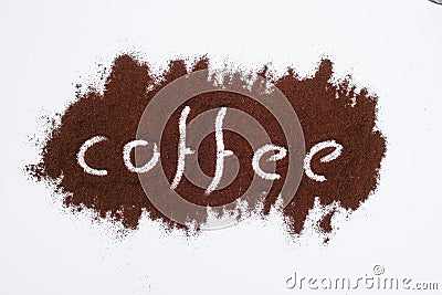Coffee word written on ground coffee layer, white background Stock Photo