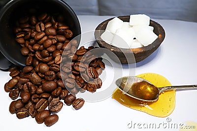 Table with coffeebeans teaspoon with honey and sugar Stock Photo