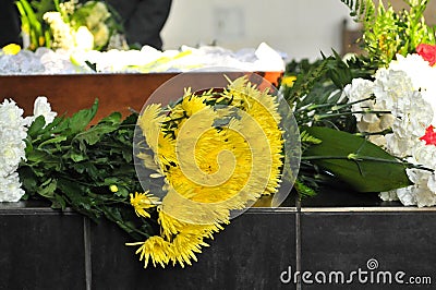 Coffin and a flower-arrang Stock Photo