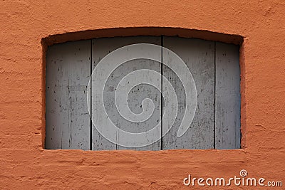 Cognac-colored stone wall with blue wooden door. Stock Photo