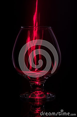 Cognac glass with fire.Fiery glass on a black background Stock Photo