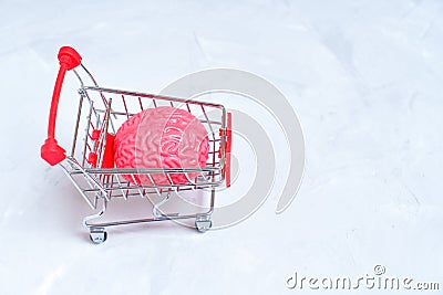 Cognitive Consumption: Jelly-Like Human Brain Model in a Push Cart Stock Photo