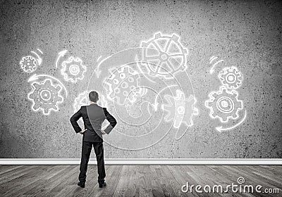 Cogwheel engine drawn on concrete wall as symbol for teamwork an Stock Photo