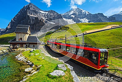 Cogwheel tourist train coming down from the mountain, Jungfraujoch, Switzerland Stock Photo