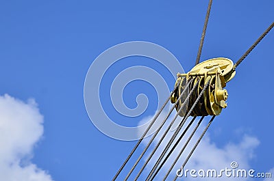 Coil for the iron cable in the tower crane against the blue sky. Mechanical component for crane operatio Stock Photo