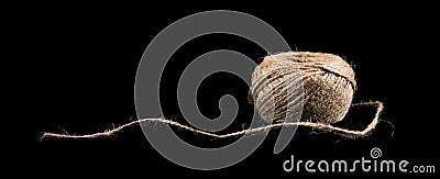 Coil of natural jute rope isolated on black background. Packaging cord roll, craft, eco-friendly natural rope coil. Tangled Thread Stock Photo