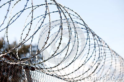 Coiled barbed wire fence Stock Photo