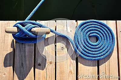 Coiled Blue Rope and Cleat Stock Photo