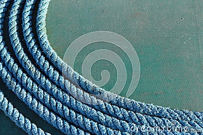 Coiled blue rope on tarpaulin Stock Photo