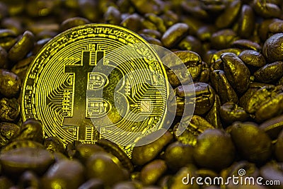 Coin cryptocurrency Bitcoin is on the coffee beans. Stock Photo