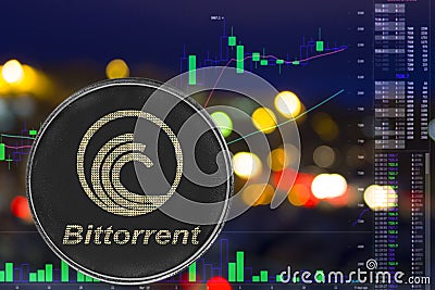 Coin cryptocurrency bittorrent on night city background and chart. Editorial Stock Photo