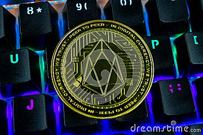 Coin cryptocurrency eos close-up of the colour-coded keyboard Editorial Stock Photo