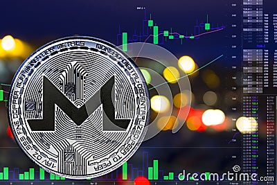 Coin cryptocurrency Monero on night Editorial Stock Photo