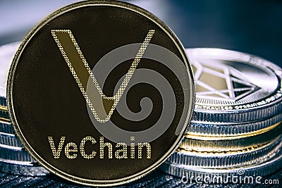 Coin cryptocurrency VeChain VET on the background of a stack of coins. MKR Editorial Stock Photo