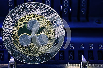 Coin cryptocurrency XRP against the numbers of the arithmometer. Editorial Stock Photo