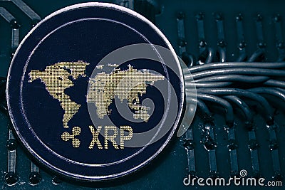 Coin cryptocurrency XRP on the background of wires and circuits. Editorial Stock Photo