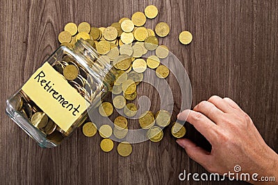 Coin glass jar container on wooden desk, retirement saving concept Stock Photo