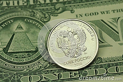 Coin in one Russian ruble against the backdrop of the US dollar Stock Photo