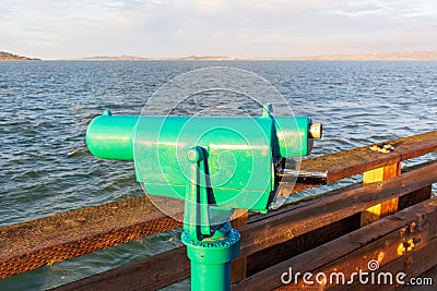 Coin operated monocular telescope for distant viewing on the pier Stock Photo