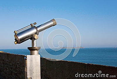 Coin operated viewfinder telescope overlooking sea Stock Photo