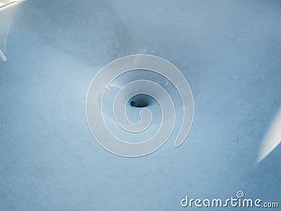 The coin rolls down in a circle on a white surface throwing at luck Stock Photo