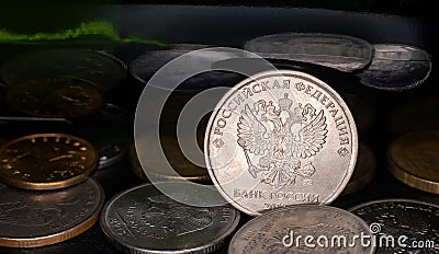 Coin ruble between other rubles and green mirror background Stock Photo