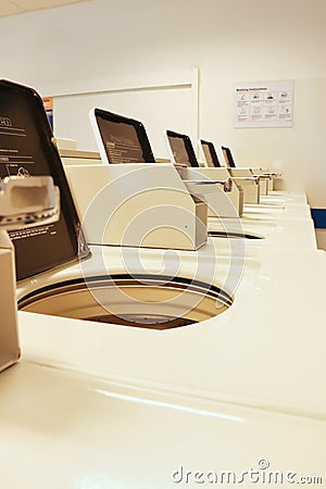 Coin slots in a row of washing machines Editorial Stock Photo