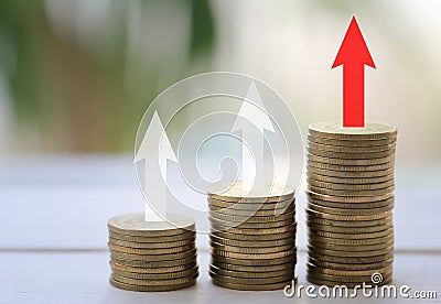 Coin stack in the concept of profitability in business investment on wooden floor. Stock Photo