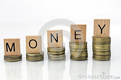 Coin stacks with letter dice - Money Stock Photo