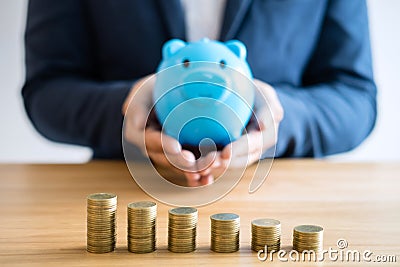 Coin stacks for step up growing business to profit and saving with piggy bank, Saving money for future plan and retirement fund Stock Photo