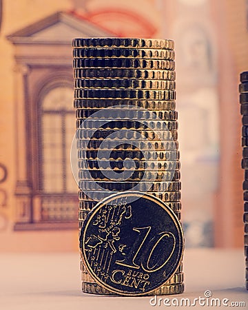 Coin of ten euro cents on the background of folded coins and a p Stock Photo