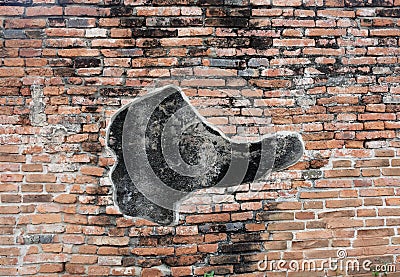 A coincidentally boot-liked on the ancient brick wall. Stock Photo