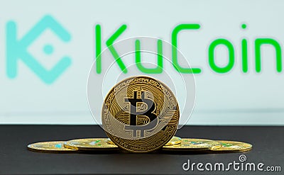 The coins of bitcoin are in front of logo of Ku Coin crypto stock exchange background. In the foreground is a BTC coins and on the Cartoon Illustration