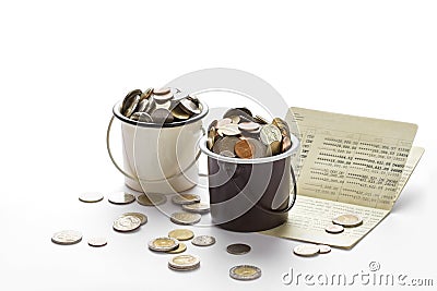 Coins in buckets and saving account passbook, book bank on white Stock Photo